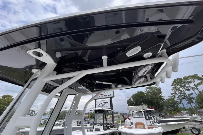 Slide: The Image of 2027 Tidewater 2500 Carolina Bay boat with sleek black T-top and modern design features. - 16