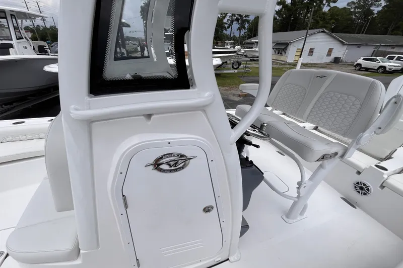 Slide: The Image of 2027 Tidewater 2500 Carolina Bay boat interior with seating and console details. - 14