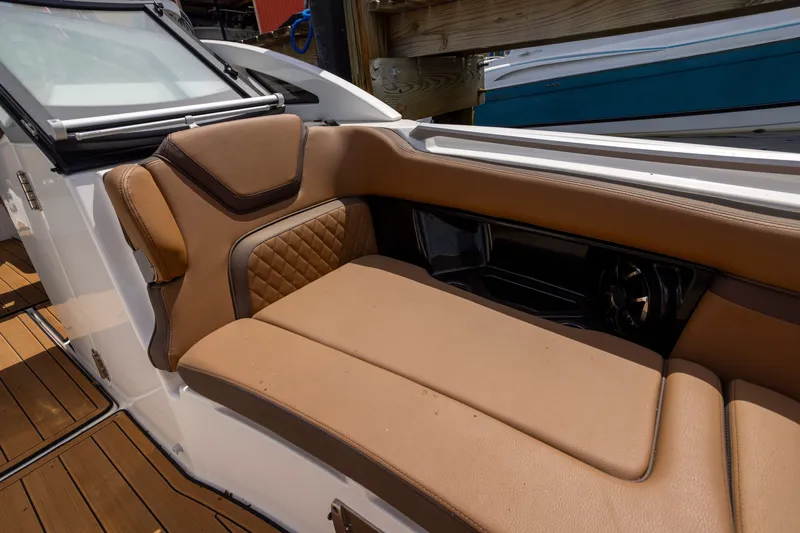 Slide: The Image of 2024 Yamaha Boats 275SE interior with luxurious tan seating and sleek design. - 3
