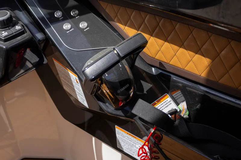 Slide: The Image of 2024 Yamaha Boats 275SE control panel with sleek design and leather accents. - 7