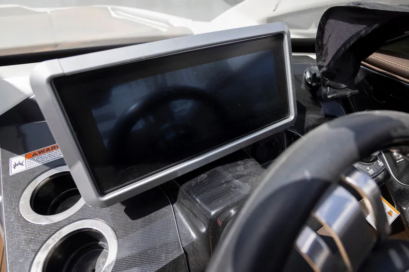 Slide: The Image of 2024 Yamaha Boats 275SE dashboard with touchscreen display and steering wheel. - 10