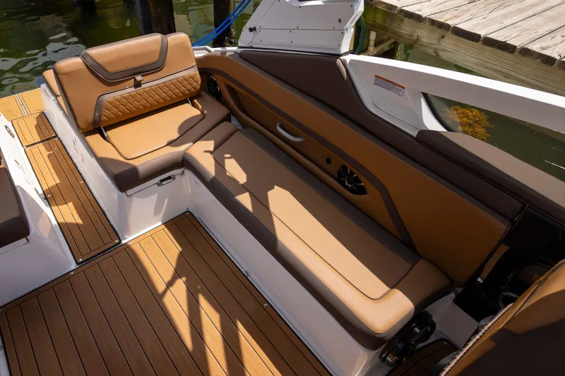 Slide: The Image of 2024 Yamaha Boats 275SE interior with luxurious tan seating and teak flooring. - 14
