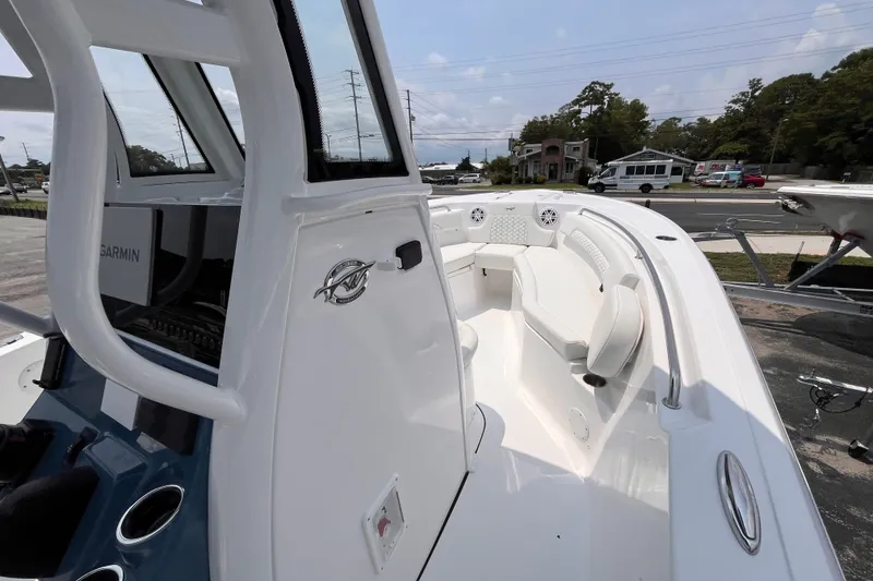 Slide: The Image of 2027 Tidewater 232 CC Adventure boat interior with seating and Garmin equipment. - 8