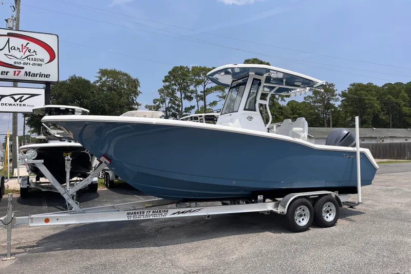 Slide: The Image of 2027 Tidewater 232 CC Adventure boat on trailer at Marker 17 Marine dealership. - 1