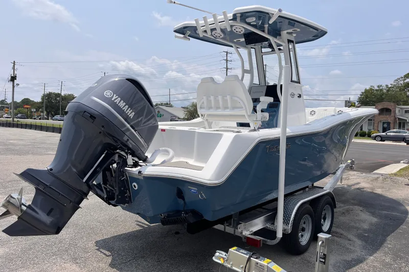 Slide: The Image of 2027 Tidewater 232 CC Adventure boat with Yamaha engine on trailer, parked outdoors. - 4