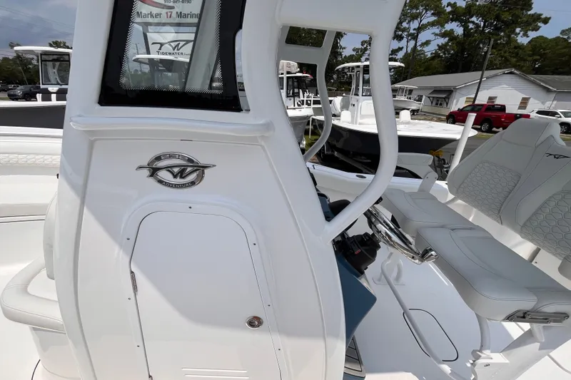 Slide: The Image of 2027 Tidewater 232 CC Adventure boat interior with steering console and seating. - 12
