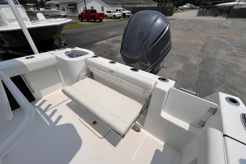 Slide: The Image of 2027 Tidewater 232 CC Adventure boat with Yamaha engine, featuring a foldable rear seat. - 14