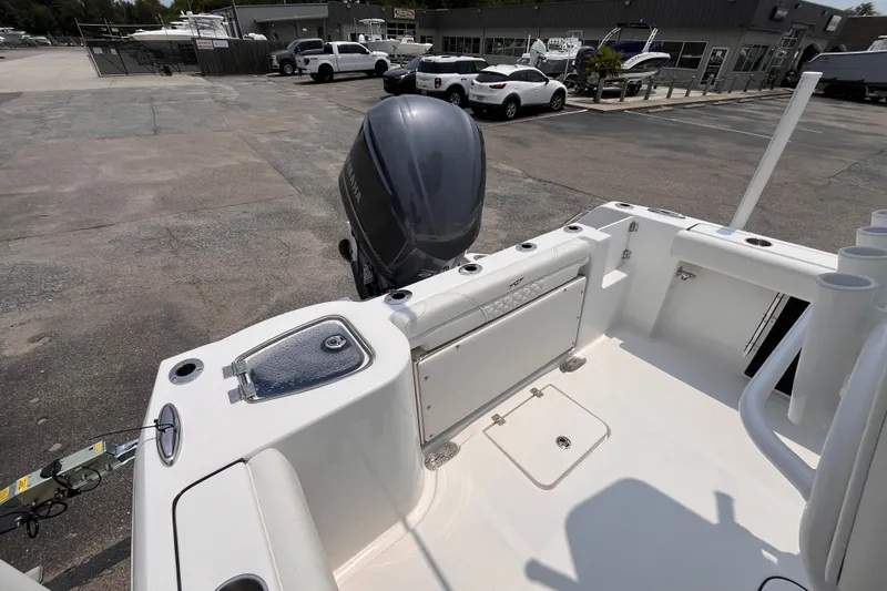 Slide: The Image of 2027 Tidewater 232 CC Adventure boat with outboard motor in a marina parking lot. - 5