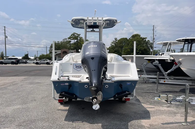 Slide: The Image of 2027 Tidewater 232 CC Adventure boat with powerful outboard motor, parked outdoors. - 3