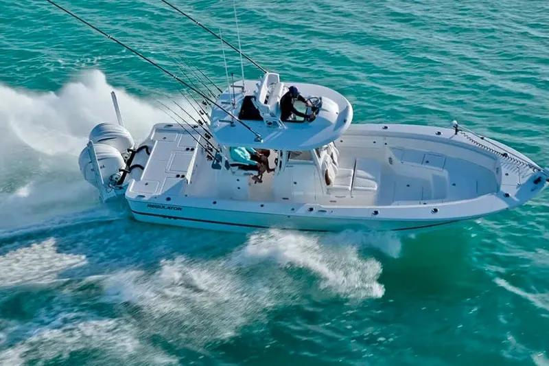 Slide: The Image of 2027 Regulator 30XO boat cruising on turquoise waters, showcasing sleek design and powerful performance. - 2