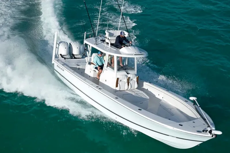 The Image of 2027 Regulator 30XO boat cruising on turquoise water, showcasing sleek design and powerful engines. - 1