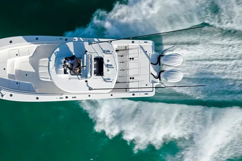 Slide: The Image of Aerial view of 2027 Regulator 30XO boat cruising on turquoise water. - 4