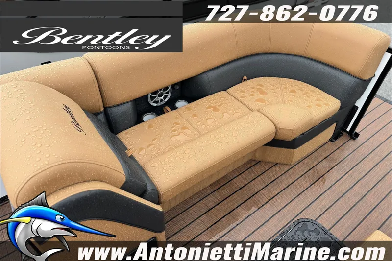 Slide: The Image of Bentley Pontoons Elite 253 Swingback 2027 with tan seating, raindrops, and marine flooring. - 3