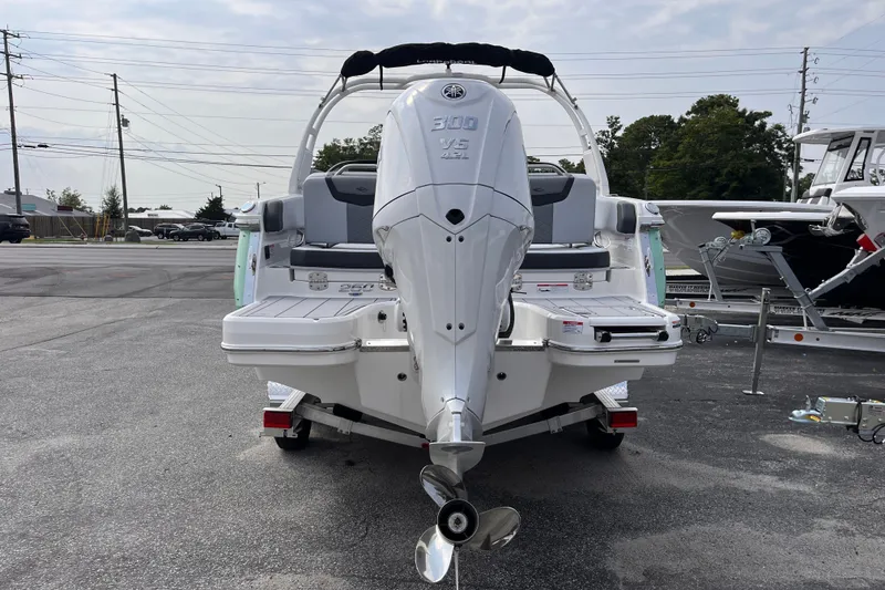 Slide: The Image of The image shows the rear of a 2025 Chaparral 250 OSX boat with an outboard motor. - 4