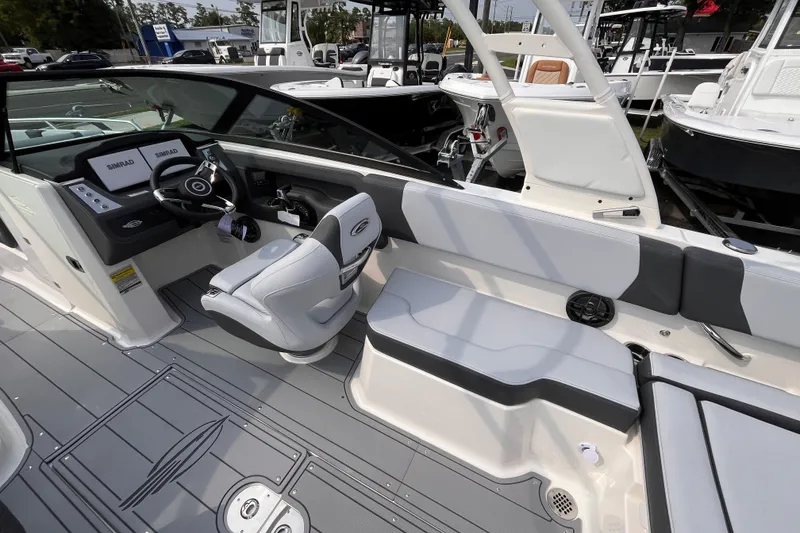Slide: The Image of The image shows the cockpit of a 2025 Chaparral 250 OSX with modern seating and controls. - 11