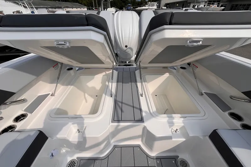 Slide: The Image of The image shows the rear area of a Chaparral 250 OSX boat with open storage compartments. - 18