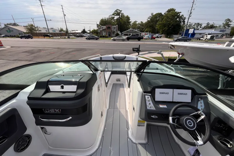 Slide: The Image of The image shows the cockpit of a 2025 Chaparral 250 OSX with modern instruments. - 14
