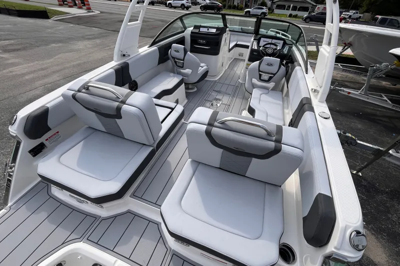 Slide: The Image of 2025 Chaparral 250 OSX: Spacious, modern deck with gray and white upholstery, ideal for leisure activities. - 6