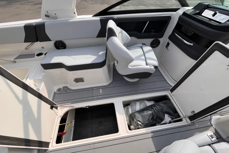 Slide: The Image of The image shows the cockpit of a 2025 Chaparral 250 OSX boat with seating and storage. - 19