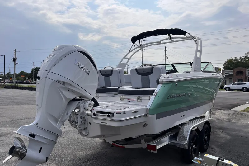 Slide: The Image of A 2025 Chaparral 250 OSX boat with an outboard motor, parked on a trailer. - 5