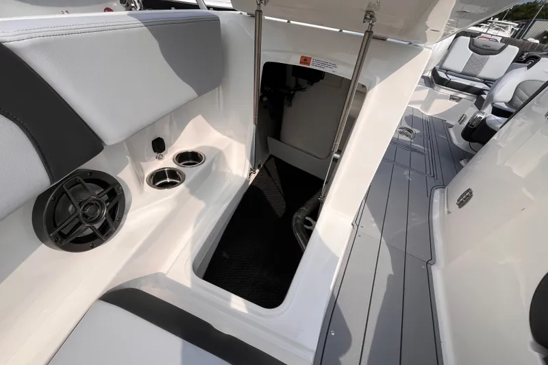 Slide: The Image of The image shows the interior of a Chaparral 250 OSX boat with seating and cup holders. - 17