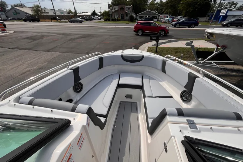Slide: The Image of The image shows the cockpit of a 2025 Chaparral 250 OSX with gray and white upholstery. - 15
