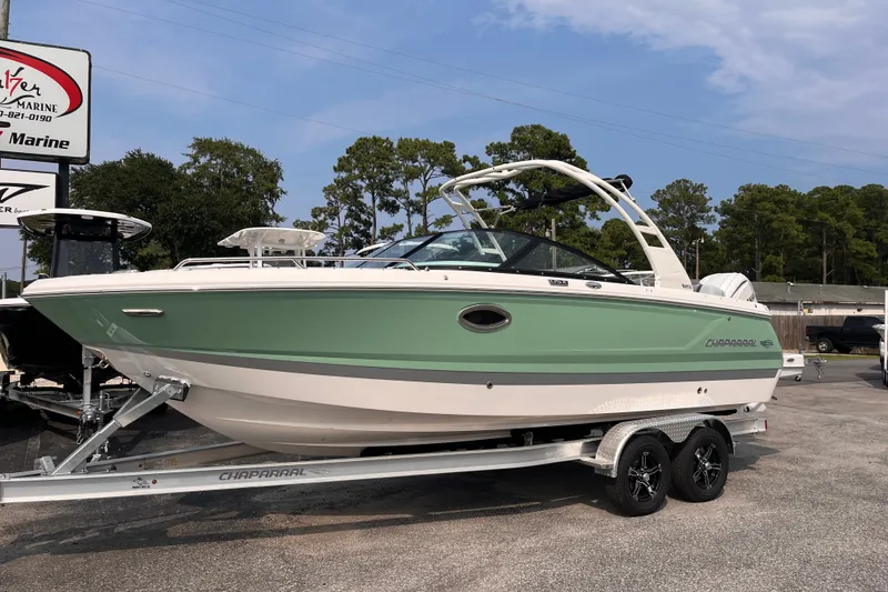 Slide: The Image of A green Chaparral 250 OSX boat from 2025 is on a trailer in a parking lot. - 2