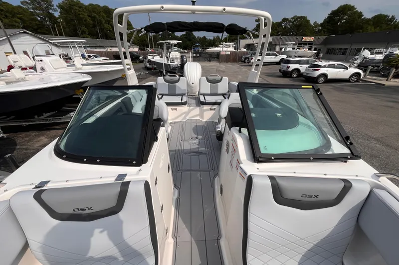 Slide: The Image of The image shows the cockpit of a 2025 Chaparral 250 OSX with modern seating and helm console. - 16