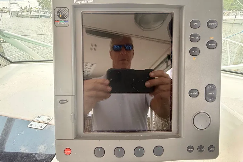 Slide: The Image of Raymarine L1260 display on 1993 Grady-White Dolphin 250 boat, reflecting a person taking a photo. - 15