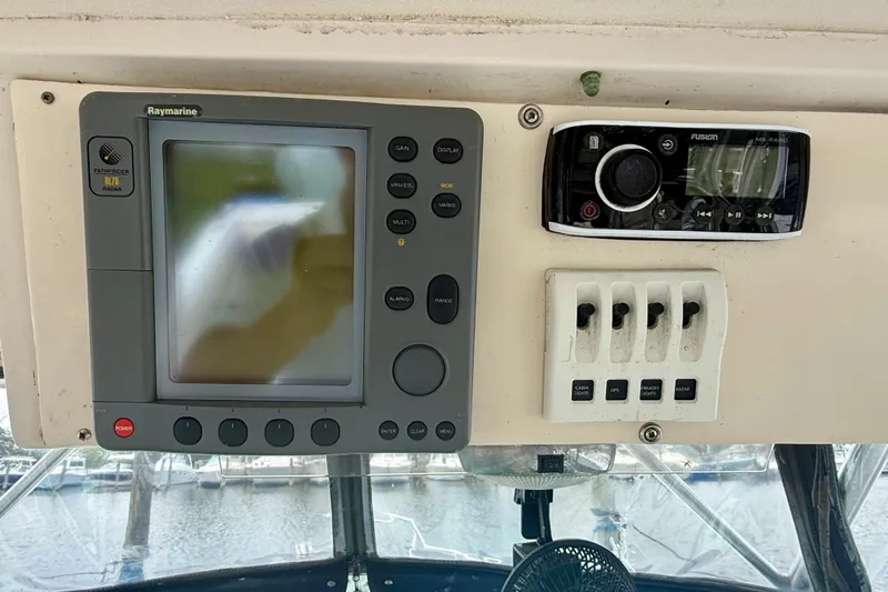Slide: The Image of Control panel of a 1993 Grady-White Dolphin 250 boat with navigation and audio systems. - 16