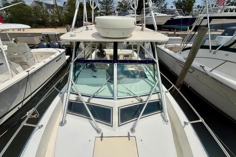 Slide: The Image of 1993 Grady-White Dolphin 250 boat docked among other vessels. - 5