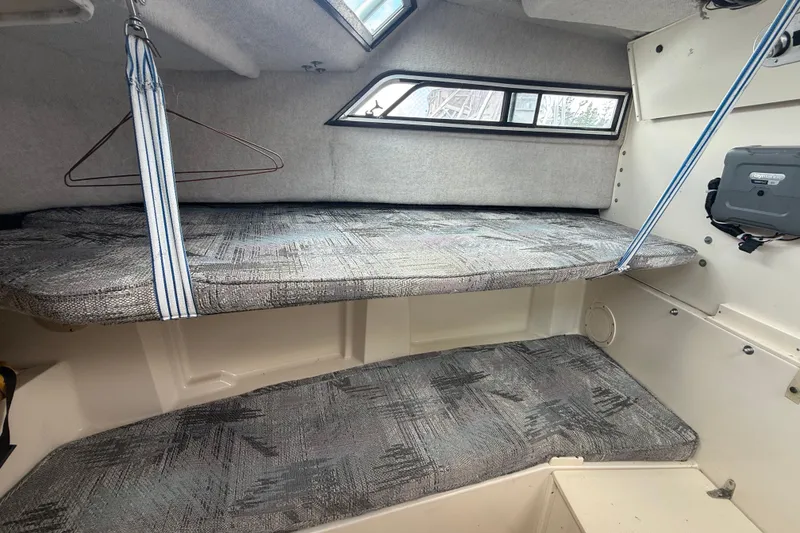 Slide: The Image of Interior cabin of 1993 Grady-White Dolphin 250 boat with bunk beds and storage. - 8