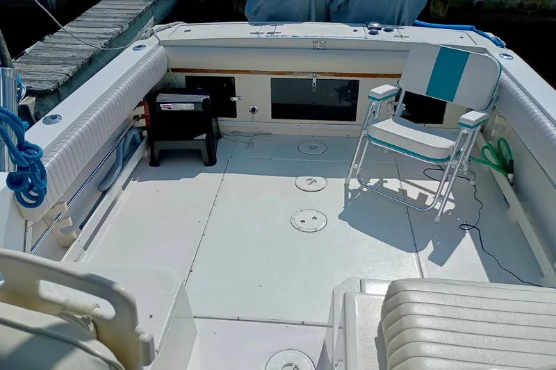 Slide: The Image of 1993 Grady-White Dolphin 250 boat interior with seating and fishing equipment. - 3