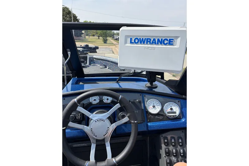 Slide: The Image of 2024 Lund 202 Pro-V GL boat dashboard with Lowrance HDS display and steering wheel. - 5