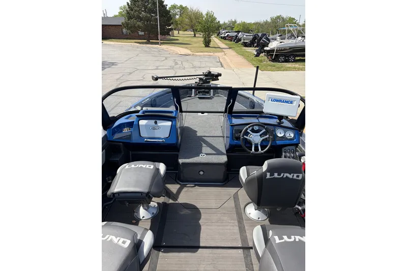 Slide: The Image of 2024 Lund 202 Pro-V GL boat interior with steering wheel and seating, featuring Lowrance equipment. - 6