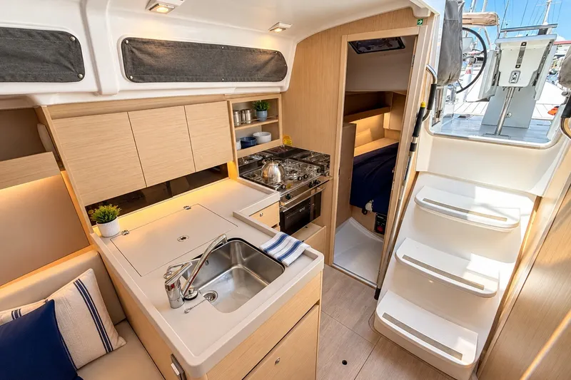 Slide: The Image of 2024 Beneteau Oceanis 34.1 yacht interior with modern kitchen and cozy cabin. - 7