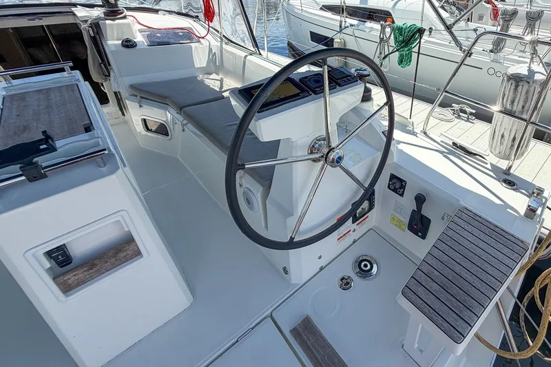 Slide: The Image of 2024 Beneteau Oceanis 34.1 yacht cockpit with steering wheel and control panel. - 35