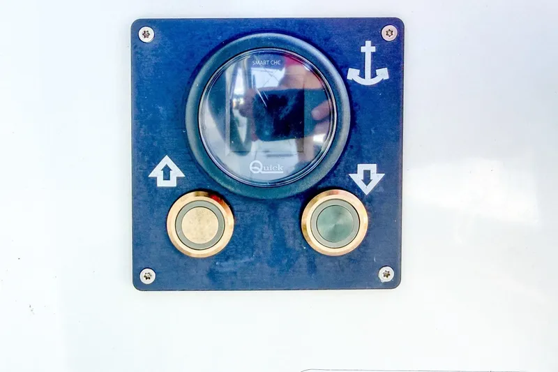 Slide: The Image of Control panel on 2024 Beneteau Oceanis 34.1 yacht, featuring anchor and directional buttons. - 41