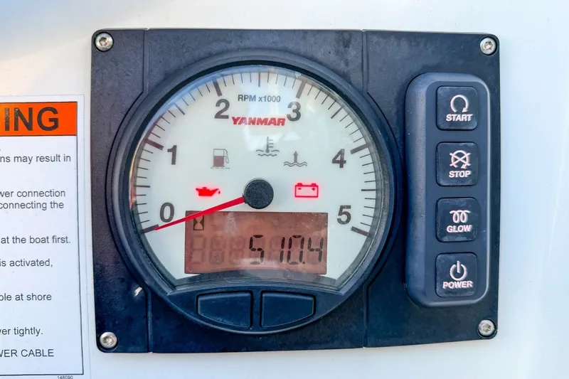 Slide: The Image of Yanmar engine control panel on 2024 Beneteau Oceanis 34.1 sailboat, displaying RPM and warning indicators. - 31