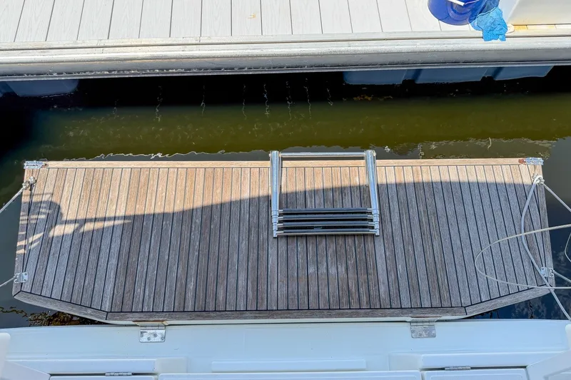 Slide: The Image of Beneteau Oceanis 34.1 2024 yacht swim platform with ladder, docked at marina. - 33