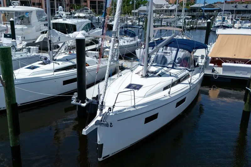 Slide: The Image of 2024 Beneteau Oceanis 34.1 sailboat docked in a marina, showcasing sleek design. - 52