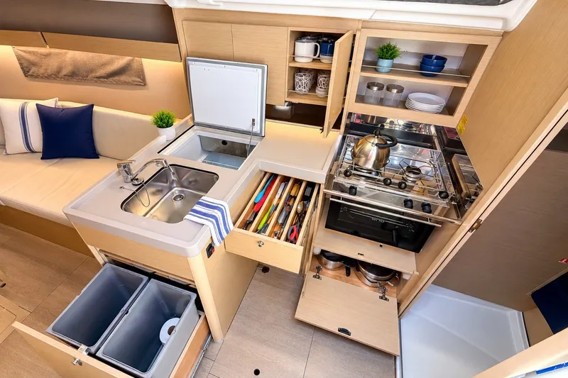 Slide: The Image of 2024 Beneteau Oceanis 34.1 yacht kitchen with modern amenities and efficient storage solutions. - 5