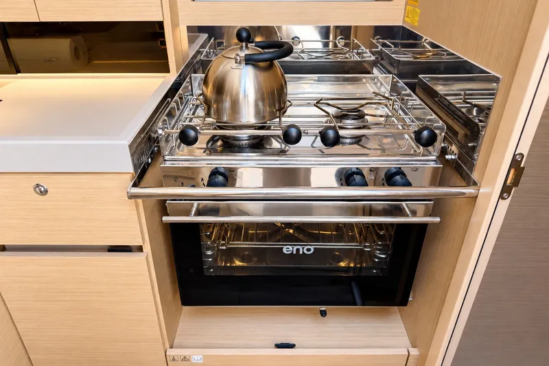 Slide: The Image of Modern kitchen in 2024 Beneteau Oceanis 34.1 yacht with stainless steel stove and kettle. - 6