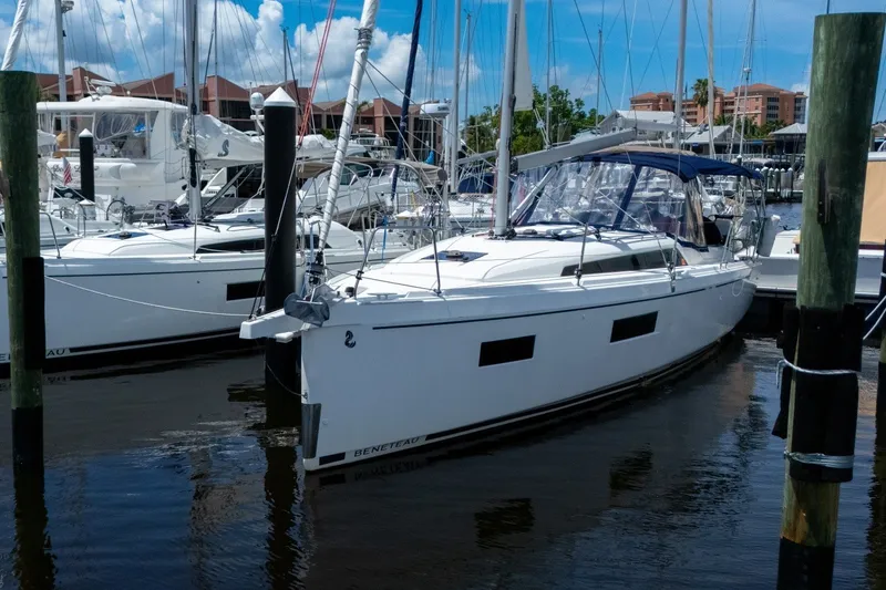 Slide: The Image of 2024 Beneteau Oceanis 34.1 sailboat docked at marina under blue sky. - 53