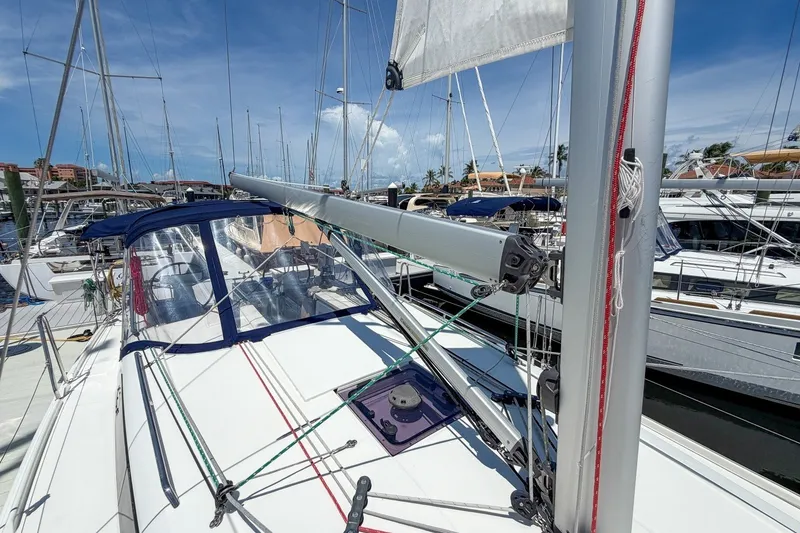 Slide: The Image of 2024 Beneteau Oceanis 34.1 sailboat docked at marina, showcasing deck and rigging. - 47