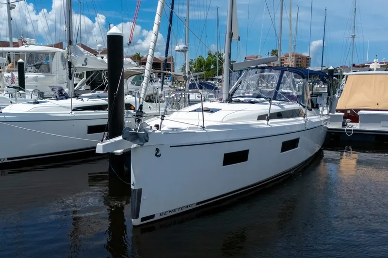 The Image of 2024 Beneteau Oceanis 34.1 yacht docked at marina under clear blue sky. - 0