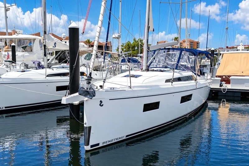 The Image of 2024 Beneteau Oceanis 34.1 yacht docked at marina under blue sky. - 0
