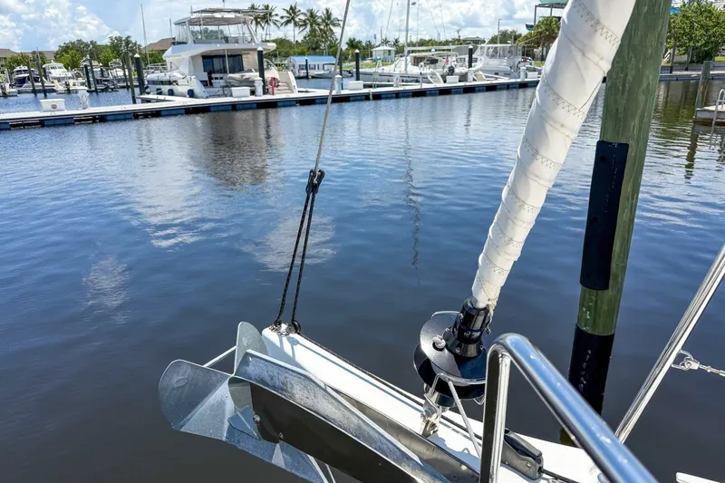 Slide: The Image of 2024 Beneteau Oceanis 34.1 sailboat anchored in a marina with clear skies. - 44