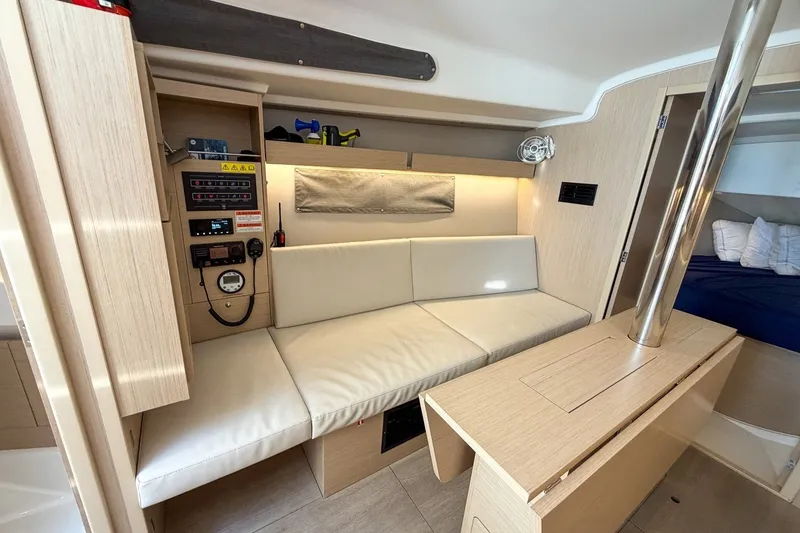 Slide: The Image of 2024 Beneteau Oceanis 34.1 interior with modern seating and control panel. - 18