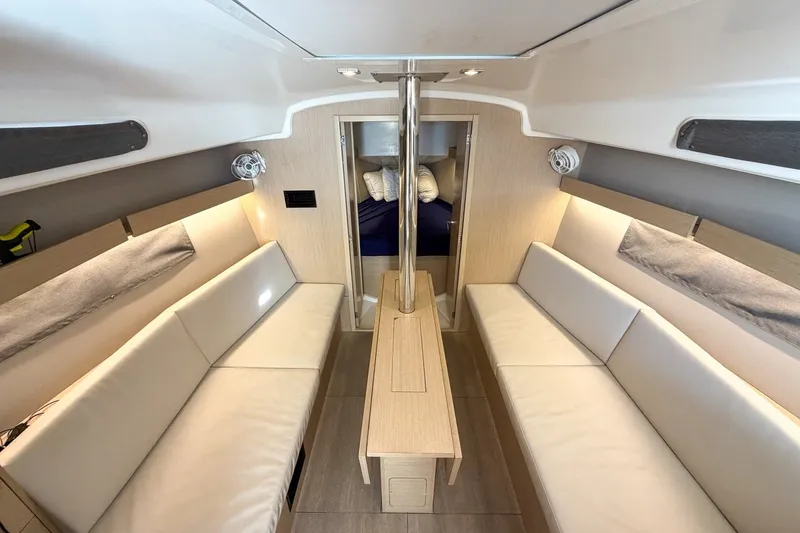 Slide: The Image of 2024 Beneteau Oceanis 34.1 interior with modern seating and elegant design. - 16